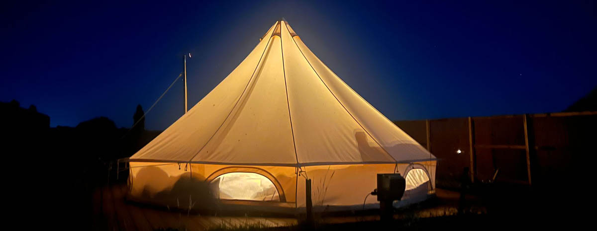 Bell Tent A Glamping in Norfolk bell tent lit internally at night