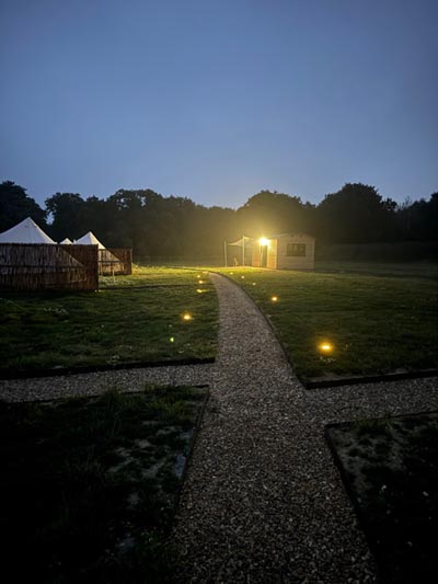 Aview of the paths leading up to Bell Tents on a Glamping in Norfolk site